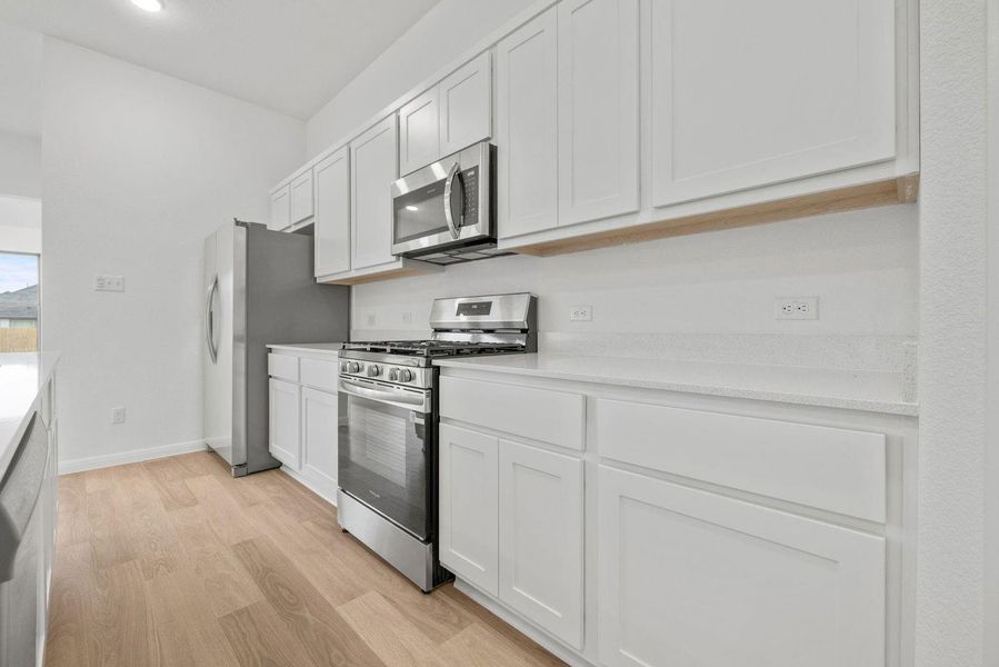Kitchen in the Quartz home plan by Trophy Signature Homes – REPRESENTATIVE PHOTO Kitchen in the Quartz home plan by Trophy Signature Homes – REPRESENTATIVE PHOTO