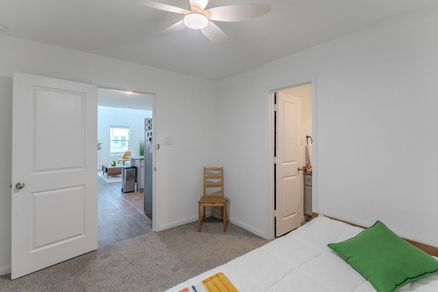 Ensuite primary bath with walk-in shower and granite countertops Ensuite primary bath with walk-in shower and granite countertops