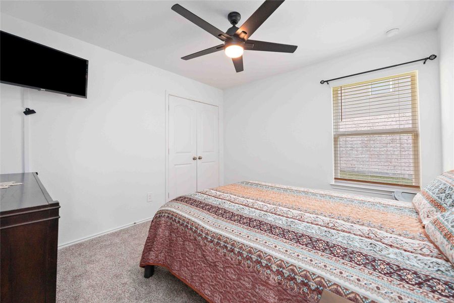 Secondary Bedroom:Comfortable and well-sized with plush carpet, ceiling fan, and flexible space for guests or a home office. Secondary Bedroom:Comfortable and well-sized with plush carpet, ceiling fan, and flexible space for guests or a home office.