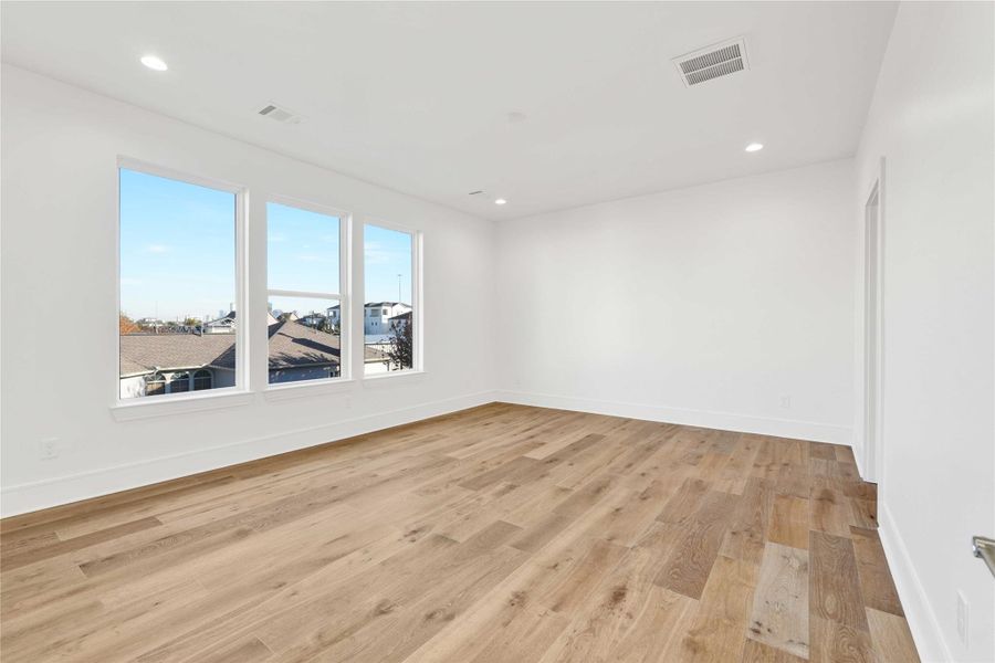 The primary bedroom on the third floor with views of downtown.