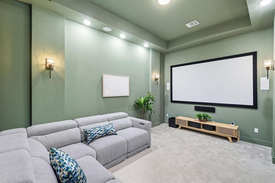 Cinema room featuring carpet flooring, recessed lighting, and a raised ceiling Cinema room featuring carpet flooring, recessed lighting, and a raised ceiling