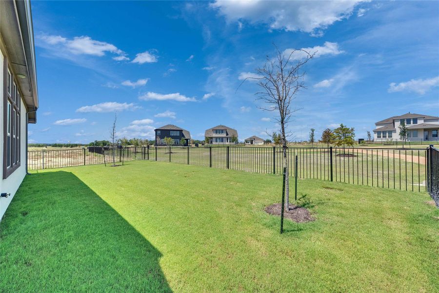 Fenced backyard featuring a residential view Fenced backyard featuring a residential view