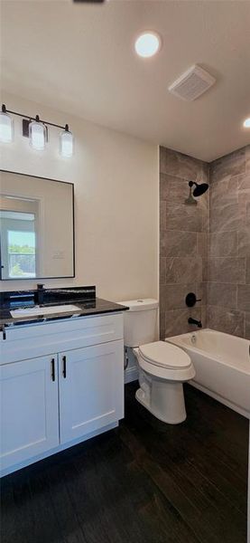Full bath with vanity, dark wood finished floors, shower / tub combination, and recessed lighting Full bath with vanity, dark wood finished floors, shower / tub combination, and recessed lighting