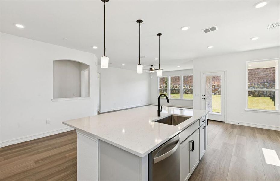 Large island overlooking gathering room and dining areas Large island overlooking gathering room and dining areas