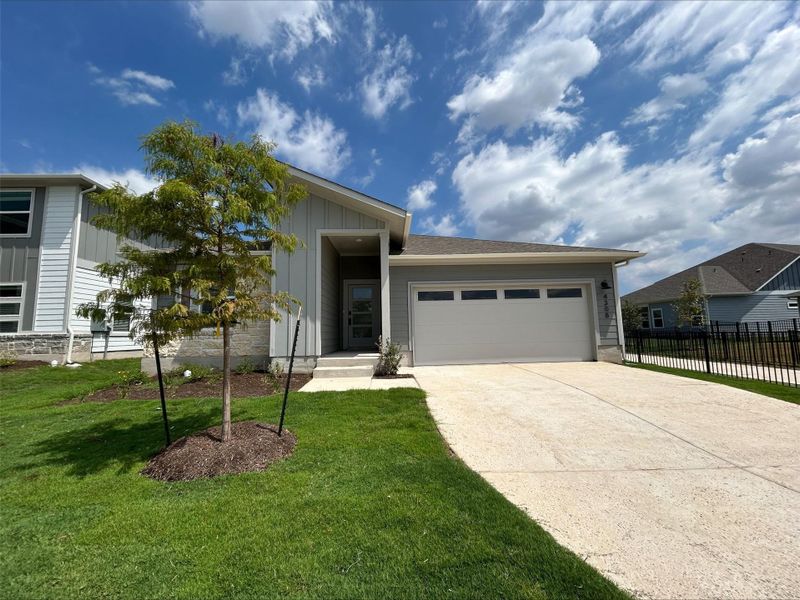 View of front facade featuring concrete driveway, an attached garage, and board and batten siding