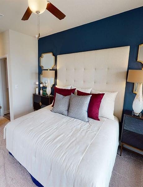 Bedroom featuring light colored carpet and a ceiling fan