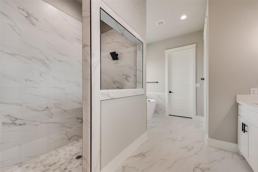 Bathroom featuring plus walk in shower, tile patterned floors, and vanity