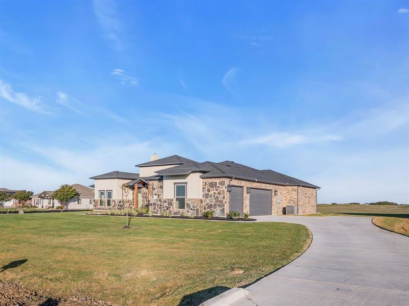 View of front of house featuring a front yard and a garage