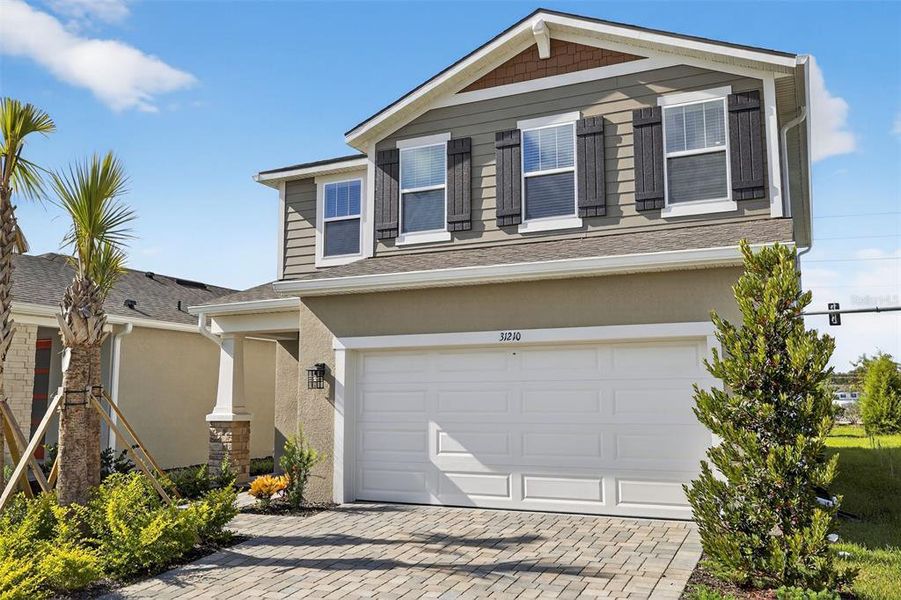 Front exterior of a new home in Pendleton at Chapel Crossings, Wesley Chapel, FL, highlighting curb appeal (Image 24). Front exterior of a new home in Pendleton at Chapel Crossings, Wesley Chapel, FL, highlighting curb appeal (Image 24).