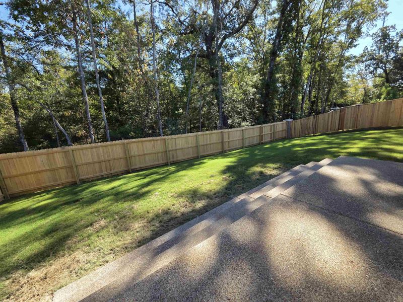 Fenced backyard featuring a patio