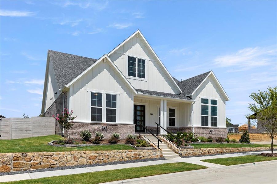 Front exterior of a new home in Painted Tree Showcase, McKinney, TX, highlighting curb appeal (Image 2).