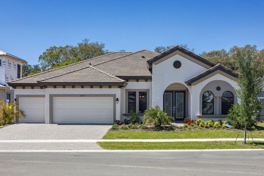 Representative exterior photo of a completed home built from the Key Largo by Homes by WestBay in Crestwood Estates, Valrico, FL (Image 16).