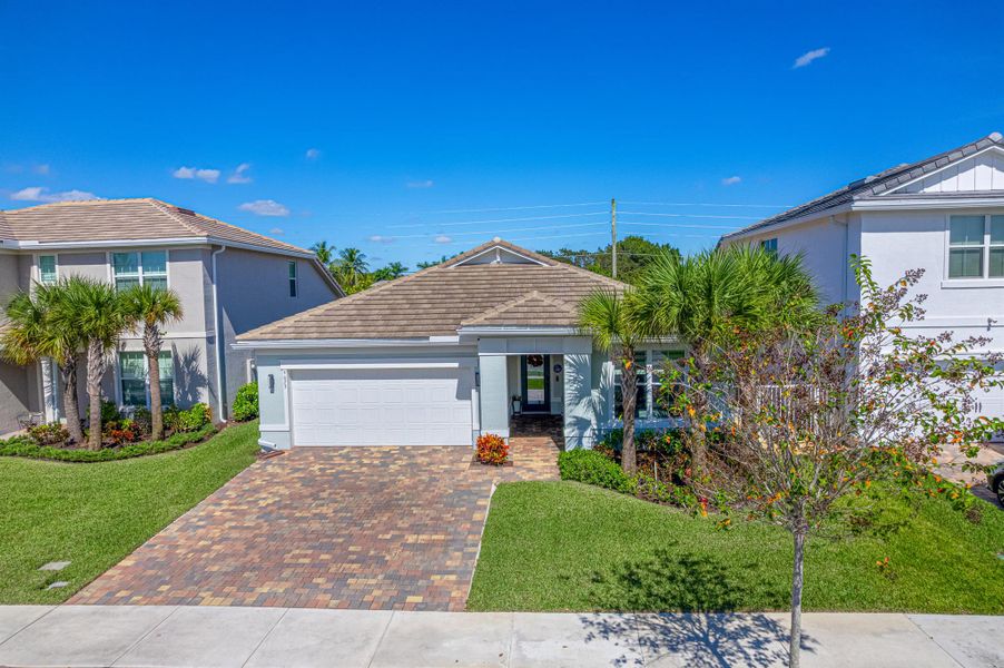 Front exterior of a new home in Windsong Estates, Lake Worth, FL, highlighting curb appeal (Image 26).