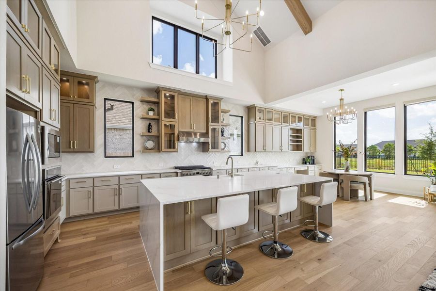 SPACIOUS KITCHEN FEATURES EXTENSIVE CABINETRY, QUARTZ COUNTERTOPS, AN OVERSIZED ISLAND WITH SEATING, STAINLESS STEEL APPLIANCES, AND A BRIGHT ADJOINING BREAKFAST AREA. SPACIOUS KITCHEN FEATURES EXTENSIVE CABINETRY, QUARTZ COUNTERTOPS, AN OVERSIZED ISLAND WITH SEATING, STAINLESS STEEL APPLIANCES, AND A BRIGHT ADJOINING BREAKFAST AREA.