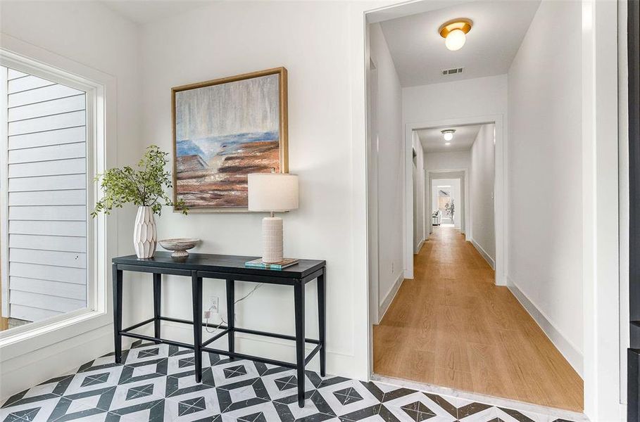 Corridor featuring light floors