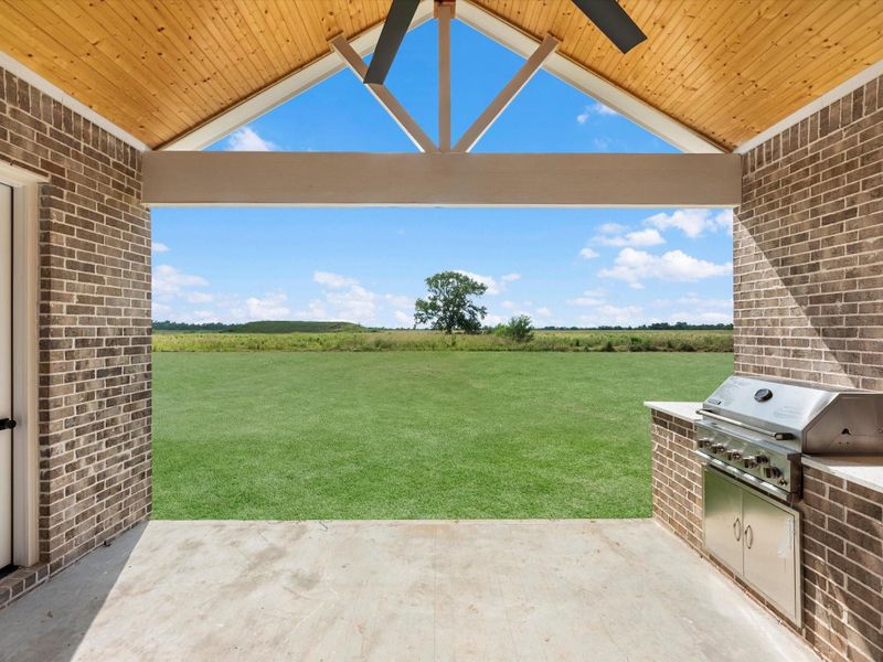 Covered patio with outdoor kitchen, prewire for cameras and tv, ceiling fan, and full outdoor bathroom. The stunner is the sliding doors!