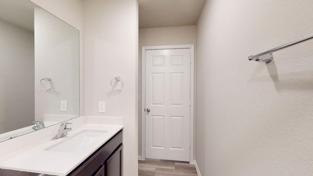 Bathroom featuring vanity and light wood-style flooring