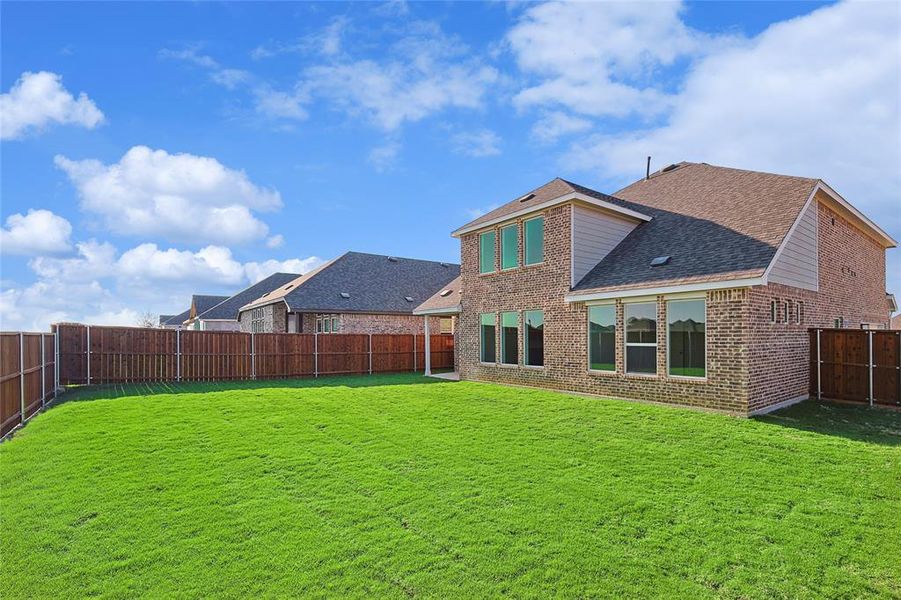 Back of house featuring a lawn