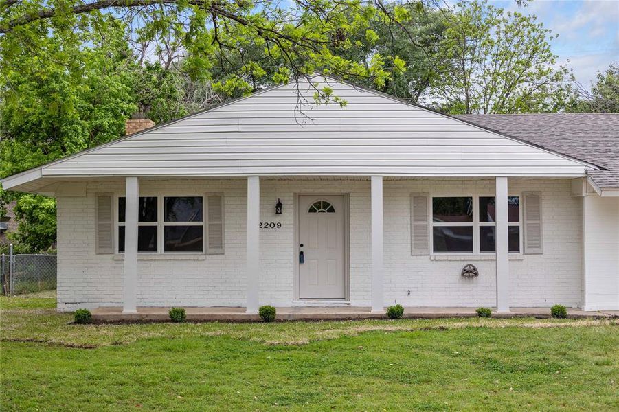 View of front of home with brick siding, a front lawn, and roof with shingles View of front of home with brick siding, a front lawn, and roof with shingles