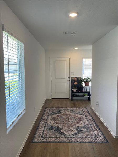 Corridor featuring dark wood finished floors and recessed lighting
