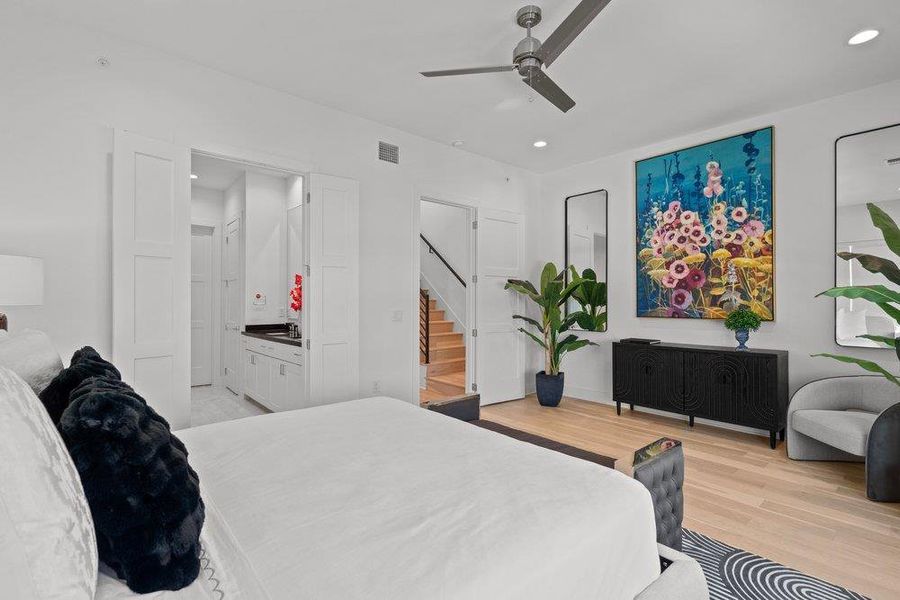 Blonde hardwood floors flow through this well-appointed bedroom featuring high ceilings. Blonde hardwood floors flow through this well-appointed bedroom featuring high ceilings.