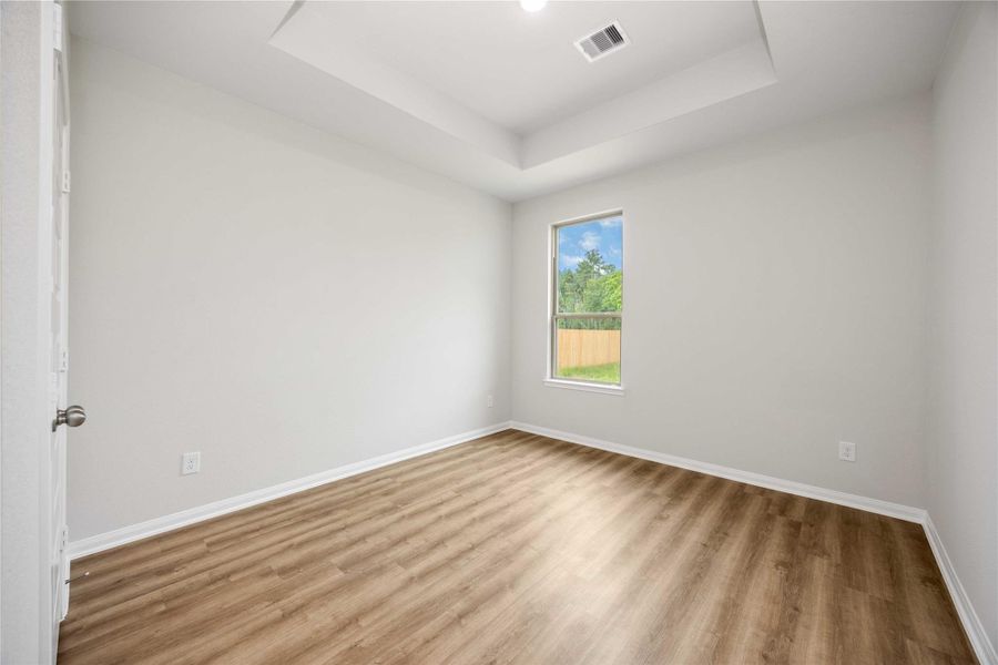 Inviting secondary bedroom with natural light, neutral tones, and ample space for guests, a home office, or hobbies.