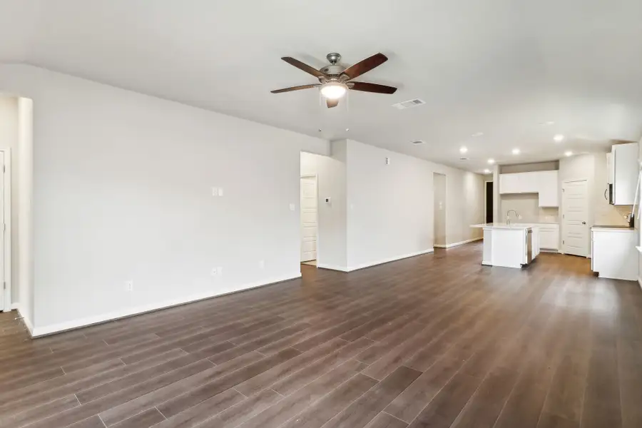 Dining room and kitchen in the Hughes floorplan at a Meritage Homes community.