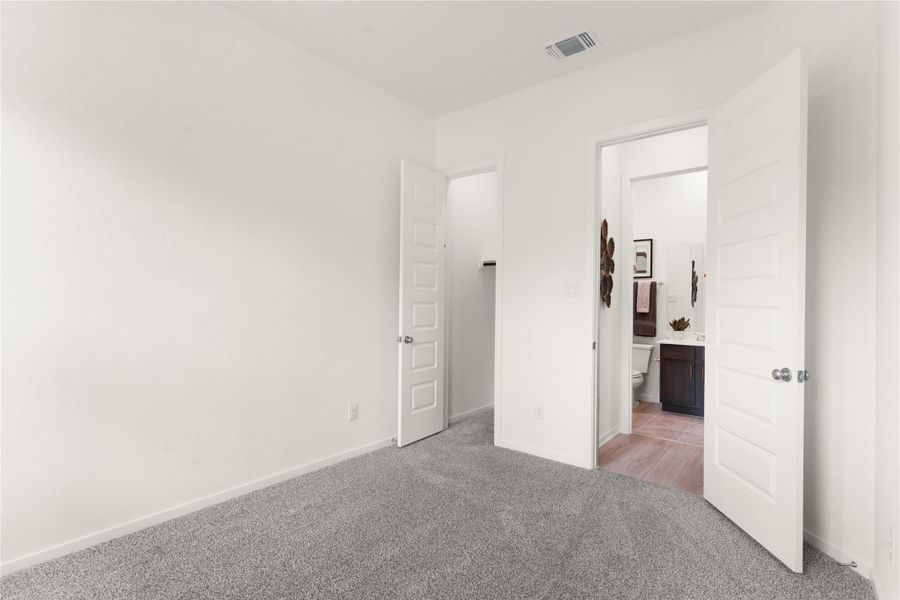 Unfurnished bedroom with carpet and baseboards Unfurnished bedroom with carpet and baseboards