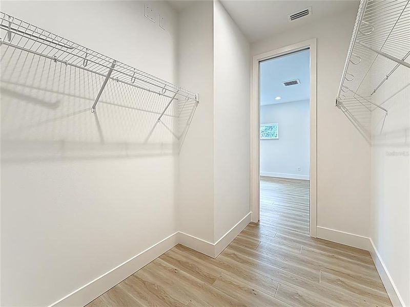 Primary suite walk-in closet. Primary suite walk-in closet.