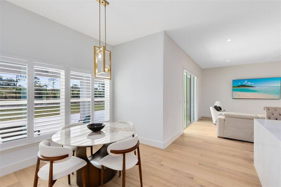 A cozy breakfast nook offers a peaceful spot to enjoy your morning coffee with serene views of the covered lanai.