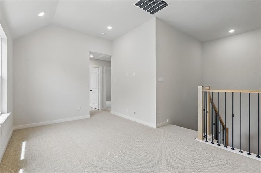 Carpeted spare room with recessed lighting and lofted ceiling