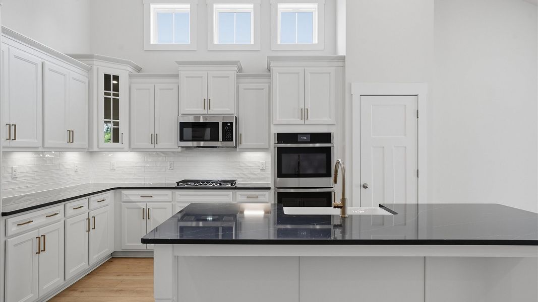 Tasteful kitchen with a streamlined island and modern finishes in a first-class DRB Homes design