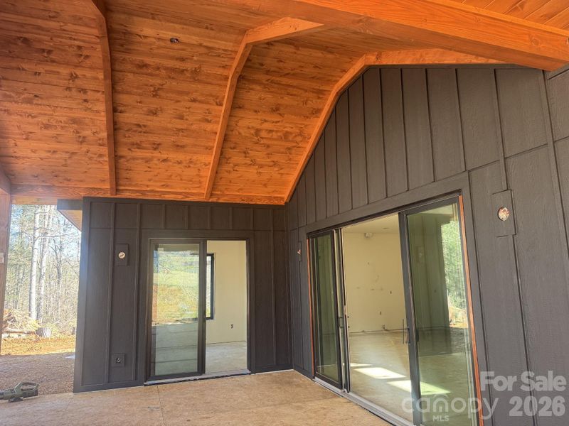 Private covered deck featuring vaulted tongue-and-groove ceilings and seamless access to the great room and dining area through sliding glass doors. Private covered deck featuring vaulted tongue-and-groove ceilings and seamless access to the great room and dining area through sliding glass doors.