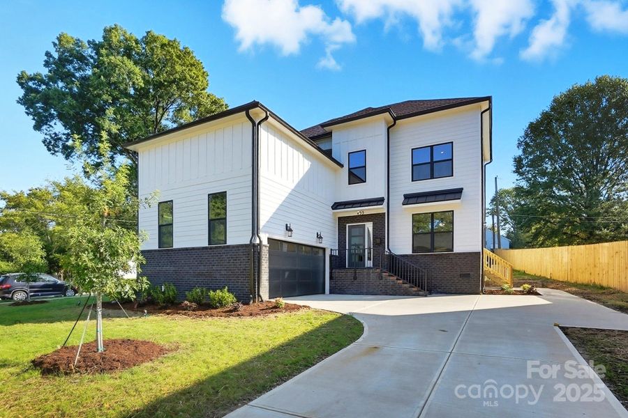 Front exterior of a new home in , Charlotte, NC, highlighting curb appeal (Image 1).