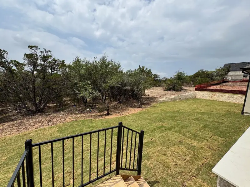 Exterior details and patio area of a home in The Hollows Sanctuary - 85', Jonestown (Image 4). Exterior details and patio area of a home in The Hollows Sanctuary - 85', Jonestown (Image 4).