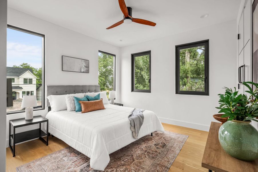 Hardwood floors and generous windows characterize this inviting, naturally illuminated bedroom. Hardwood floors and generous windows characterize this inviting, naturally illuminated bedroom.