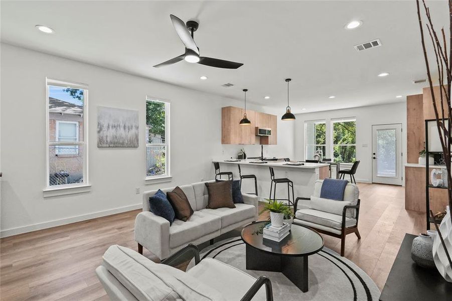 Living room with ceiling fan and light wood-type flooring