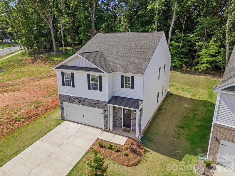 Front exterior of a new home in Reedy Creek Preserve, Charlotte, NC, highlighting curb appeal (Image 29).