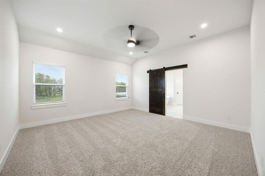 Spacious room featuring light-toned carpet, recessed lighting, and a contemporary ceiling fan