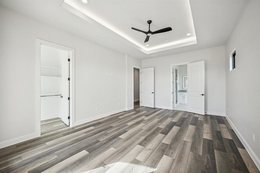 Upstairs guest bedroom with front-facing private balcony, large walk-in closet, and private en suite bathroom. (Bedroom 4 of 5)