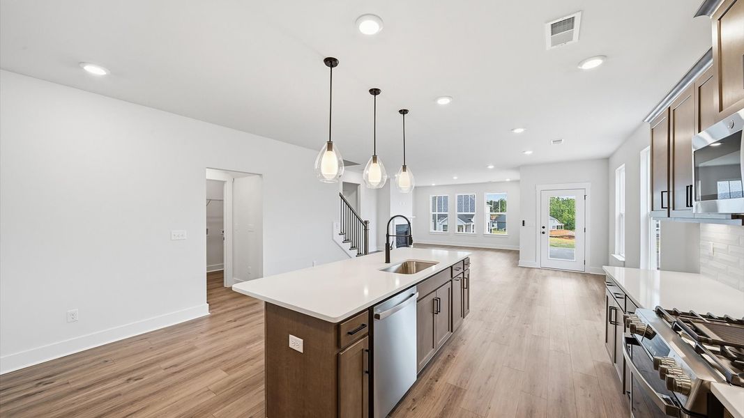 Well-designed kitchen with a center island and tasteful finishes that elevate everyday living at the Iris Meadows community