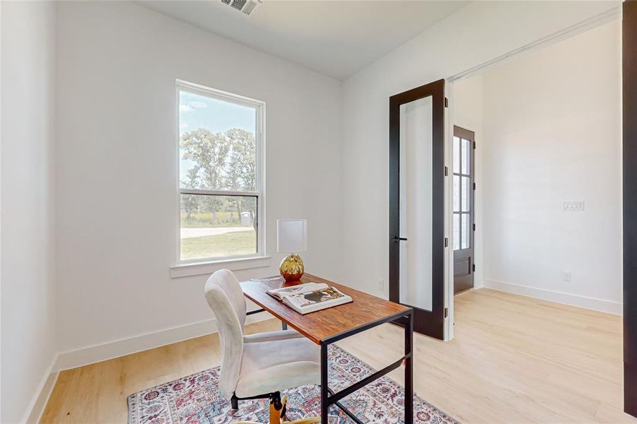 Home office with light wood-type flooring