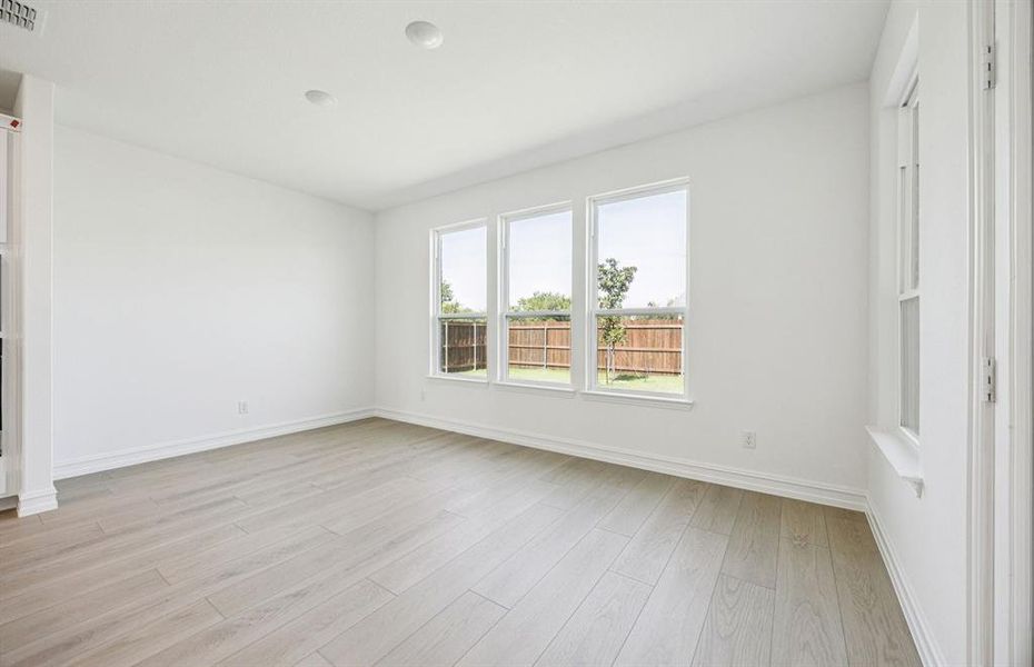 Dining nook off kitchen with large windows Dining nook off kitchen with large windows