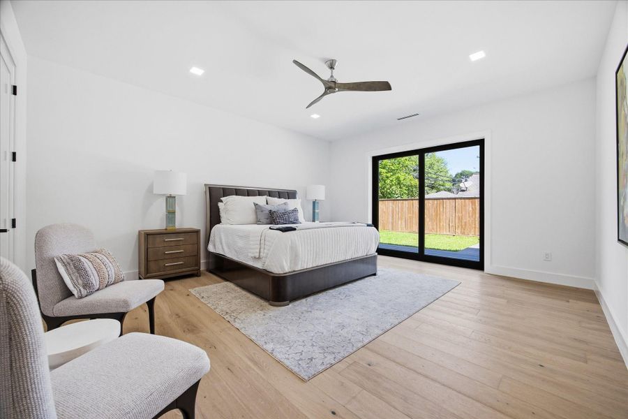 Privately tucked behind a concealed entry, this downstairs primary suite offers a rare blend of seclusion and sophistication.