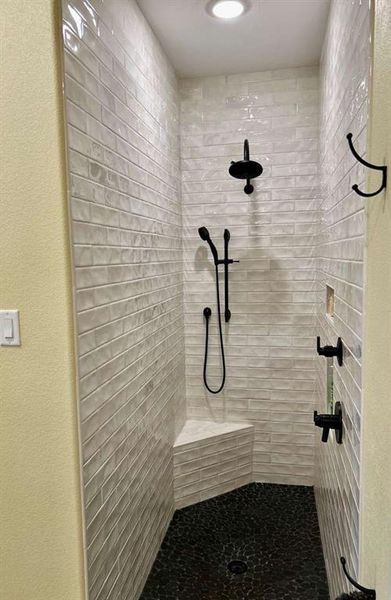 Bathroom featuring tiled shower