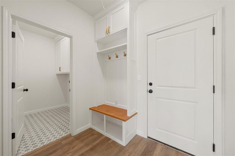 Mudroom with light wood-type flooring and baseboards Mudroom with light wood-type flooring and baseboards