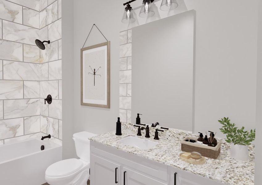 A modern bathroom with marble-tiled walls and a white bathtub. It features a large mirror, granite countertop, black fixtures, a framed wall art, and a plant.
