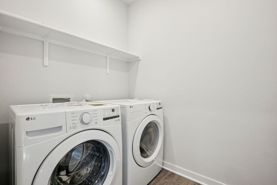 A white washing machine and a dryer in a room. A white washing machine and a dryer in a room.