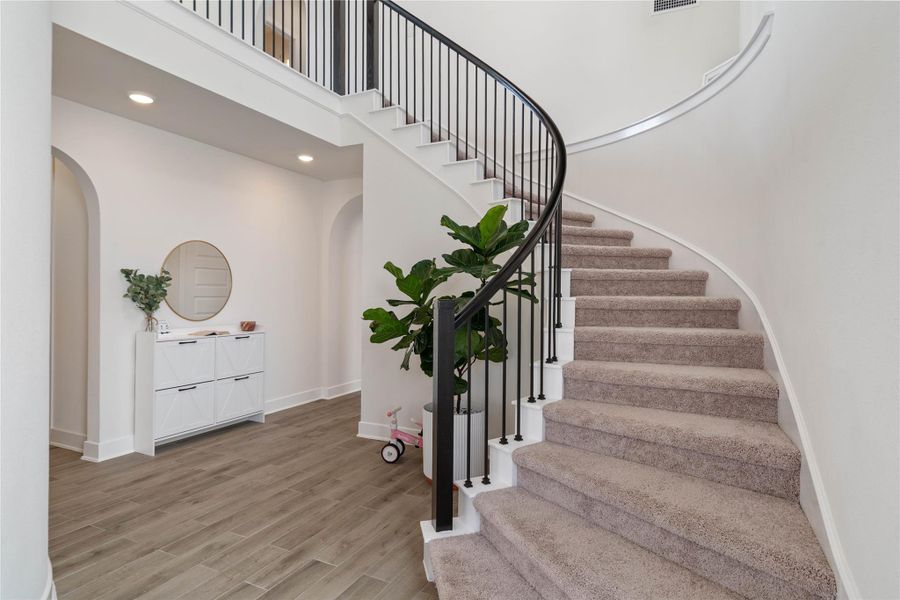 Enjoy a lovely view of the spiral staircase that leads to the 2nd level as soon as you enter.