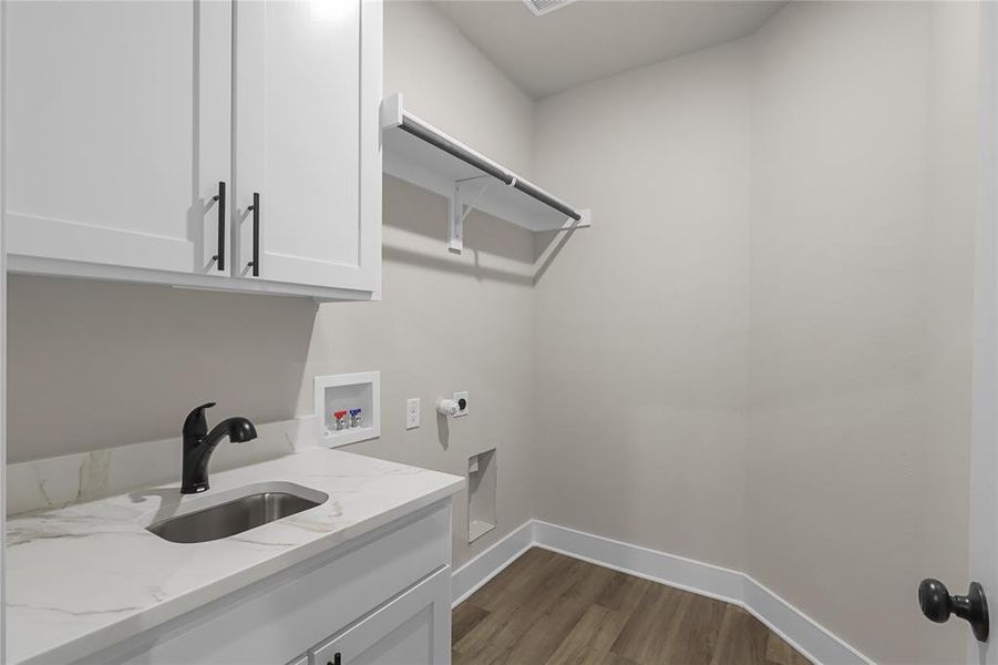 Laundry room with sink, cabinets, dark hardwood / wood-style flooring, hookup for a washing machine, and electric dryer hookup